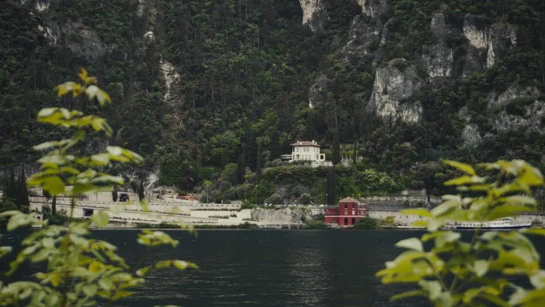 Lakefront villa surrounded by lush mountains, ideal leadership retreat venue.