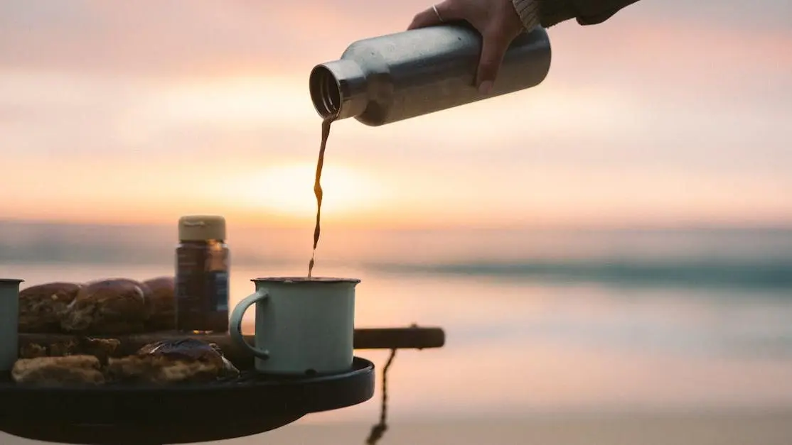 Peaceful sunrise beach with hot coffee, aligning with retreat details and schedule theme.