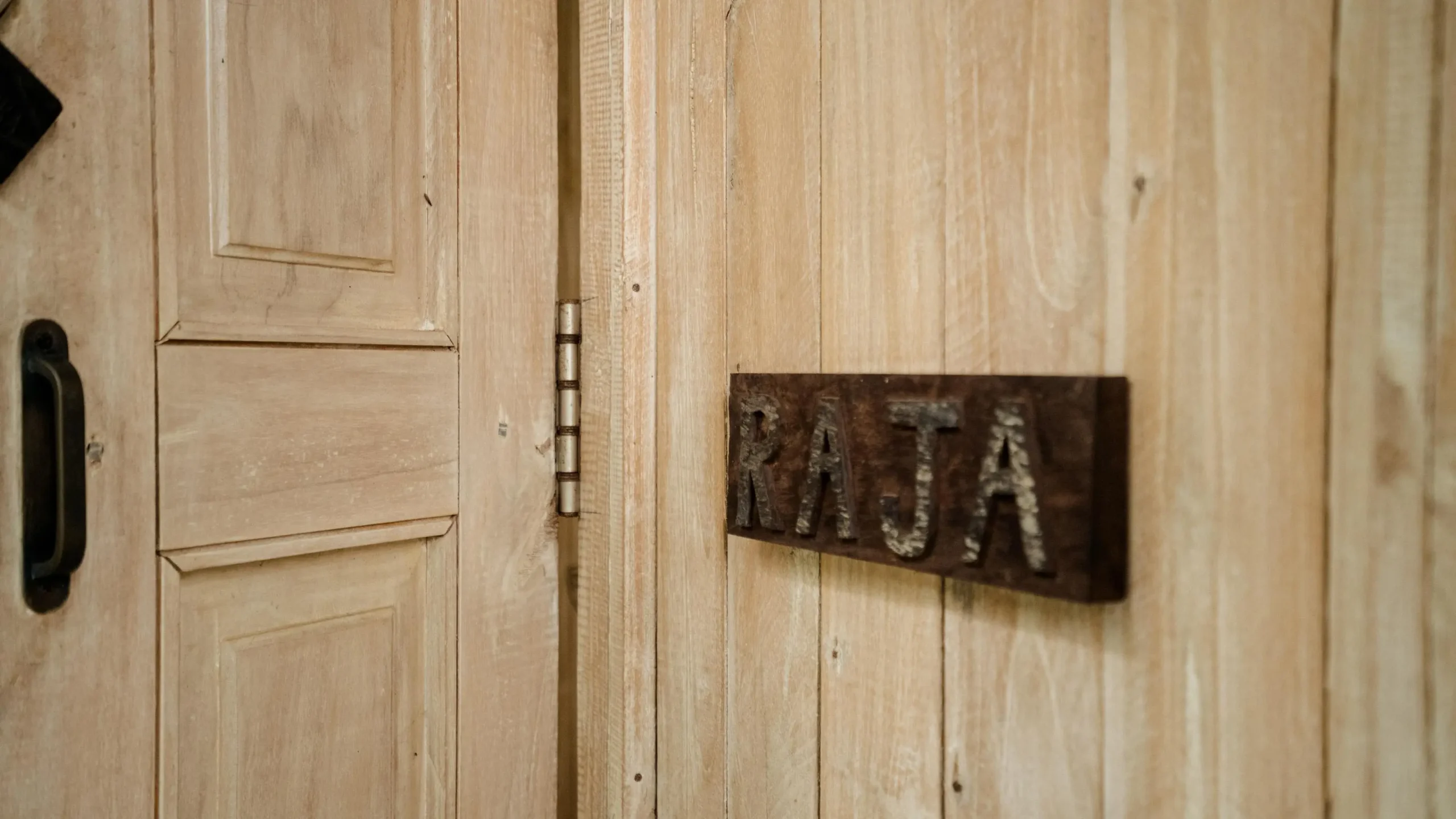 Wooden door with metal handle at a wellness retreat for mental health