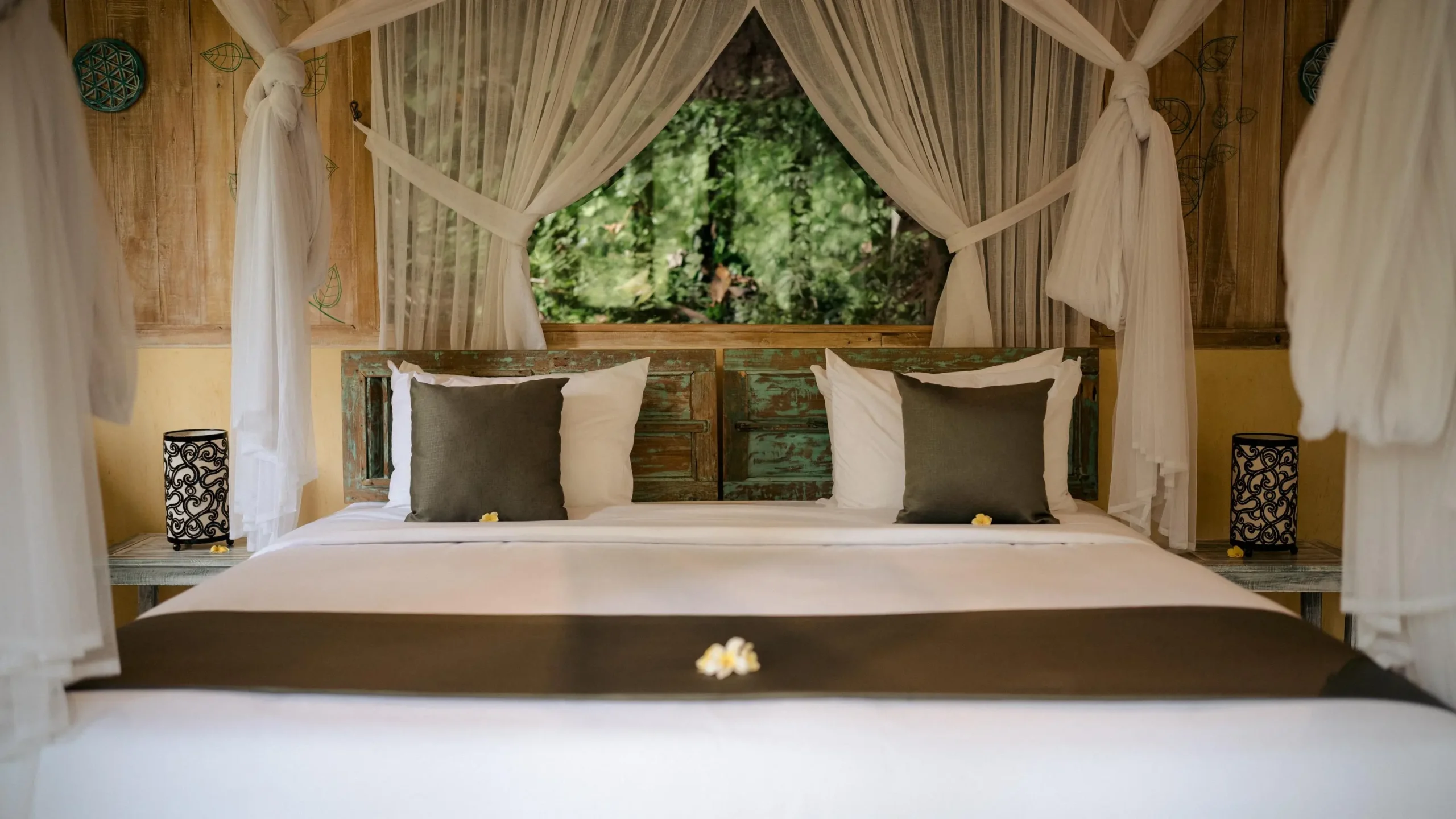 Traditional Balinese bed with canopy, decor related to Bali festivals in background