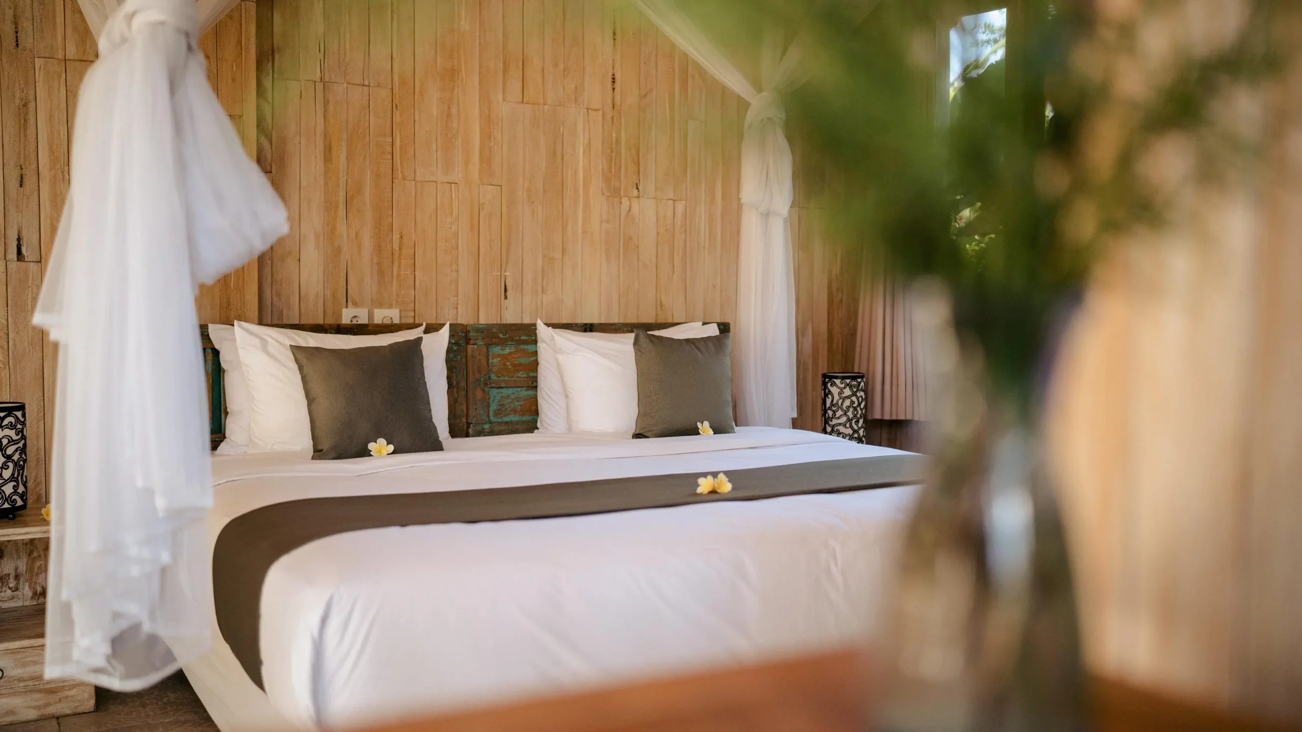 Luxury bed with white canopy in lush Bali jungle retreat