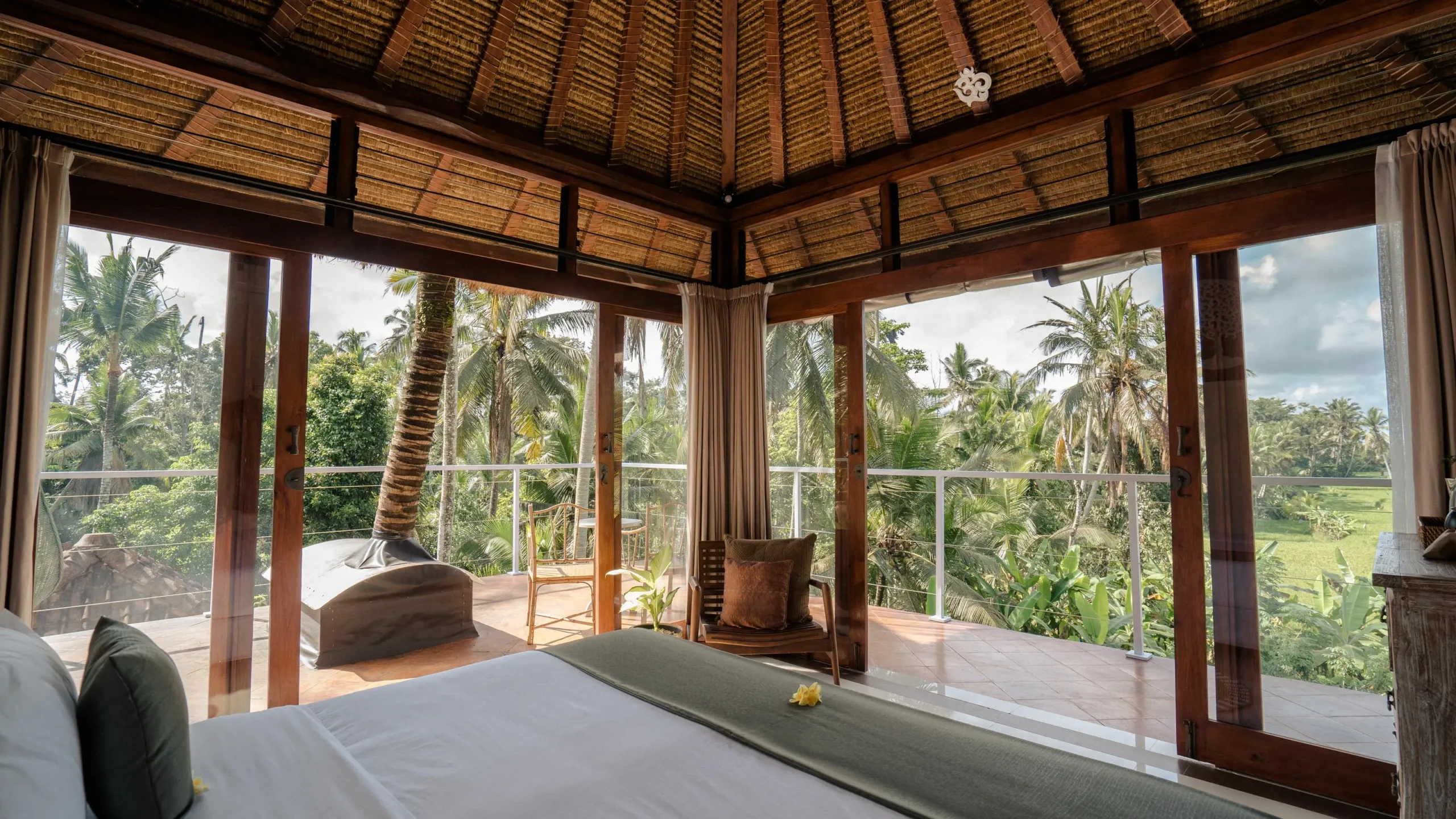 Luxury yoga retreat Bali suite with serene bedroom and panoramic lush green field view