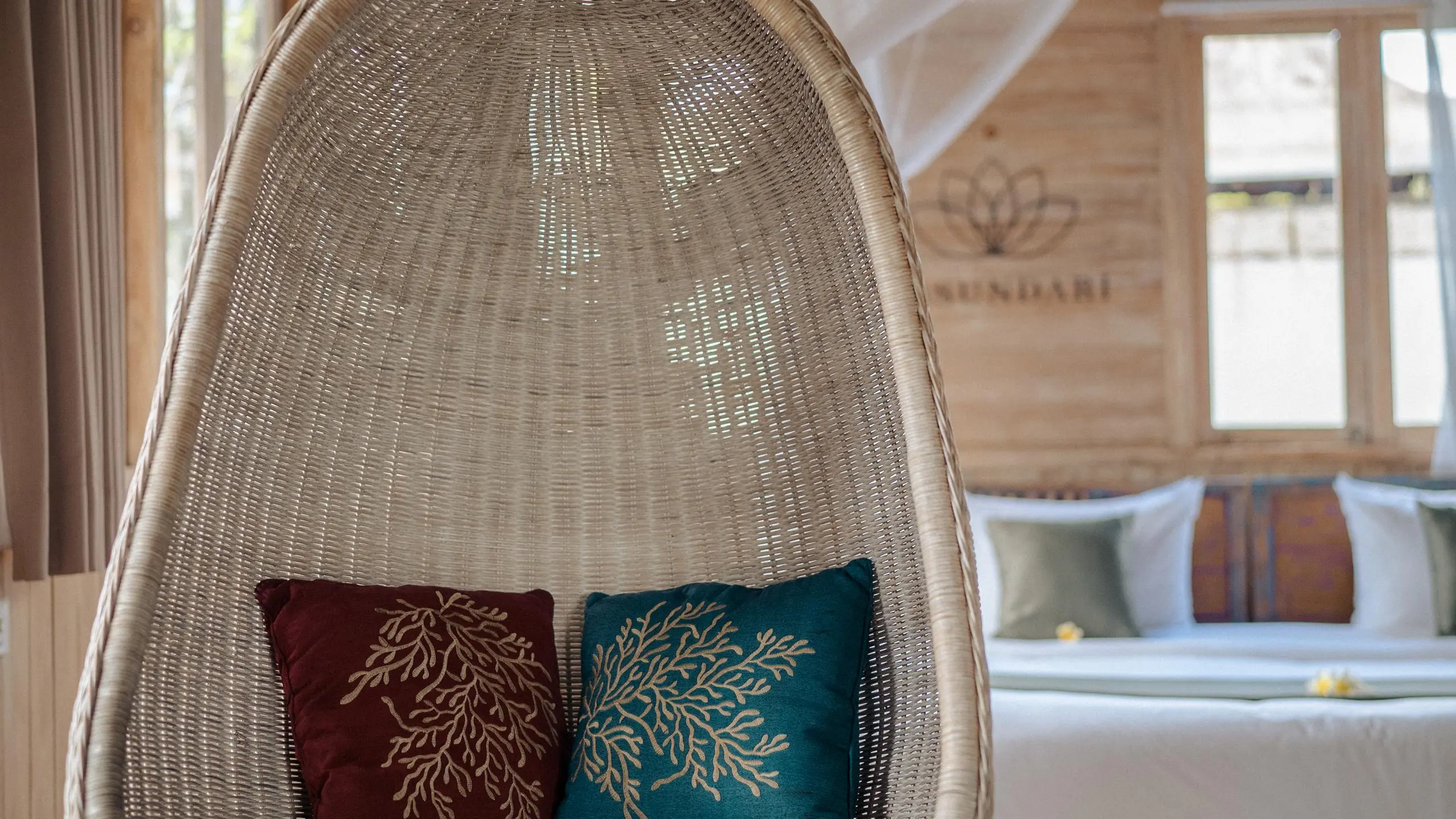 Person relaxing in a white hanging chair, illustrating benefits of meditation and relaxation