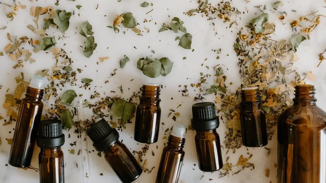 Essential oils for meditation with brown glass bottles and dried herbs arranged in a calming setting