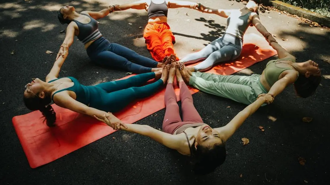 Women practicing yoga outdoors together, illustrating gratitude practice benefits for well-being.