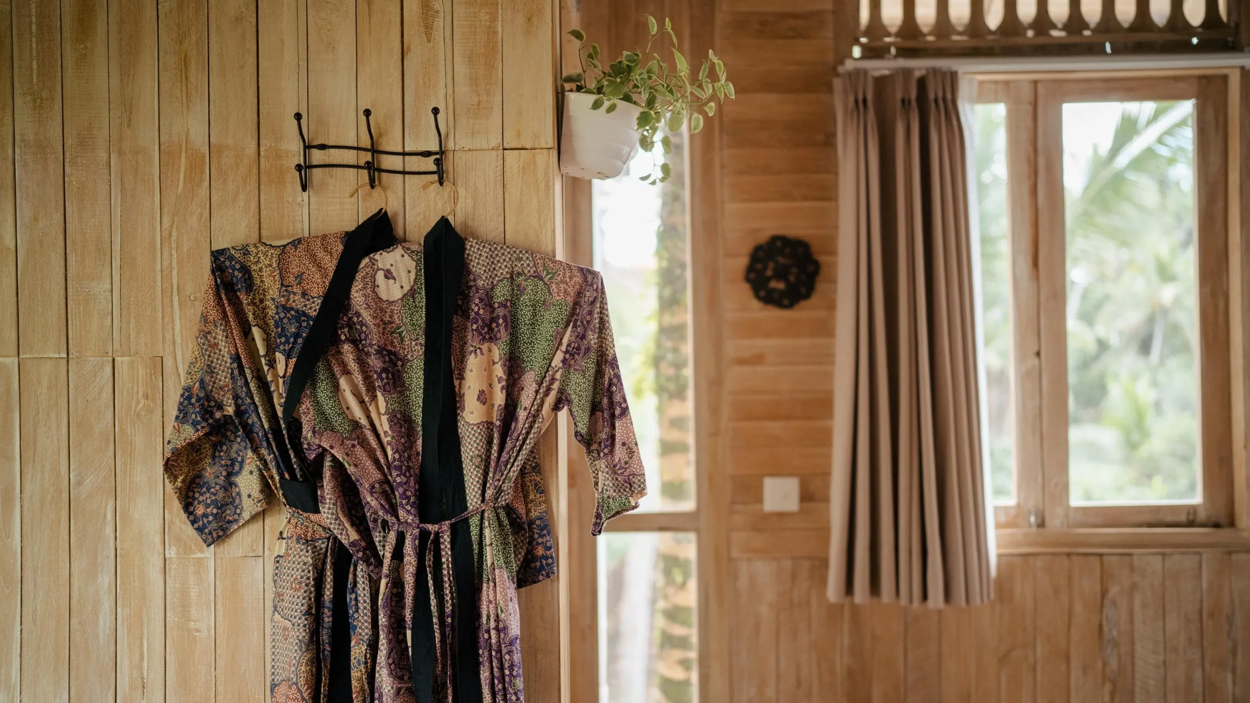Cover photo for article on what are chakras: minimalist room with robe hanging on wall