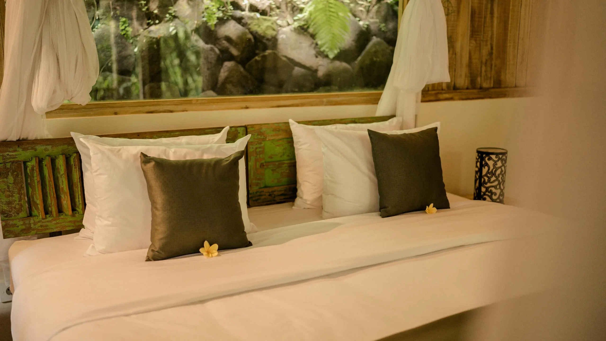 Serene bedroom with white bedding for restful sleep after a kundalini yoga practice