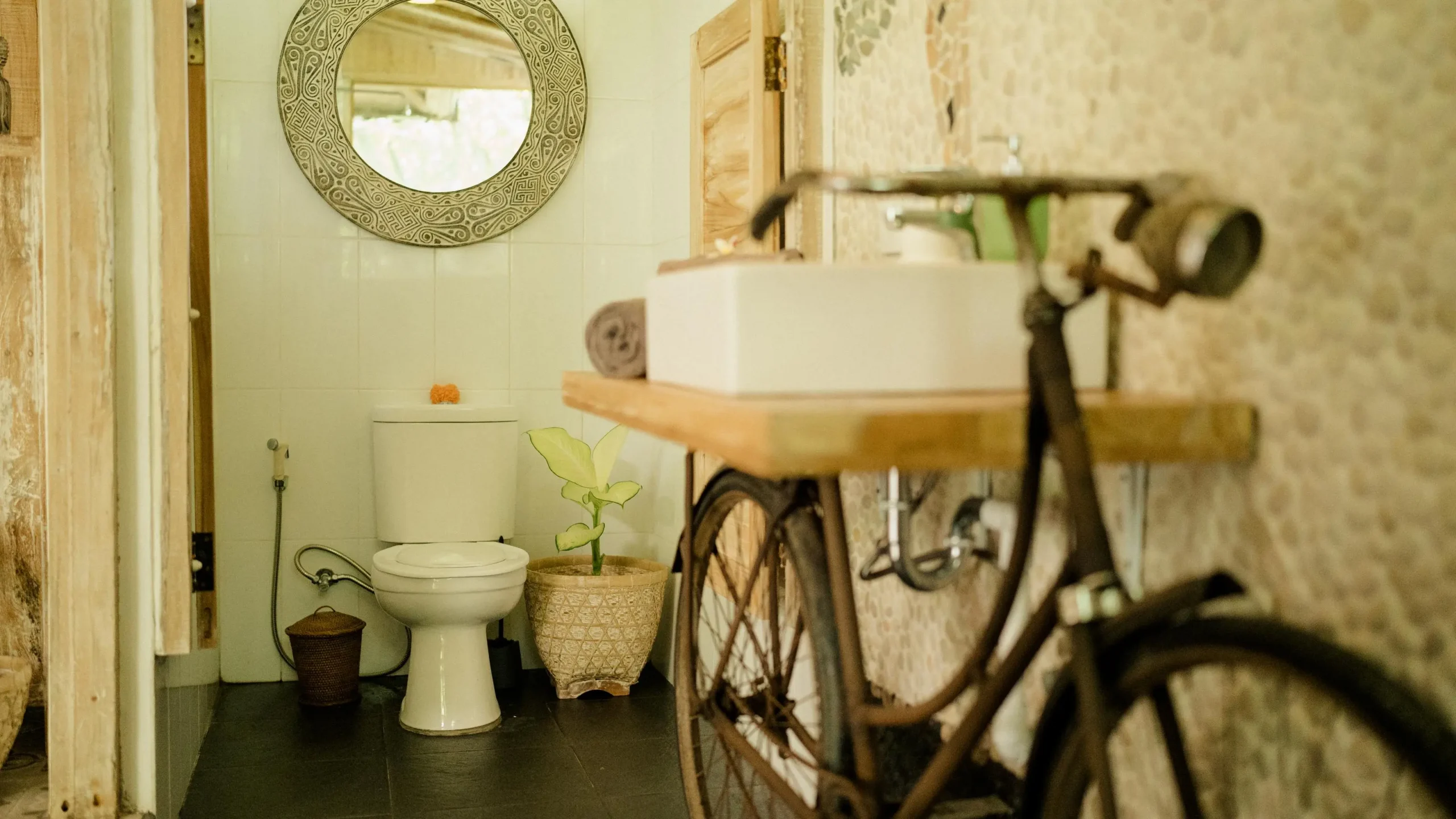 yoga vs gym contrast shown by a bike leaned in a bathroom with sink and mirror