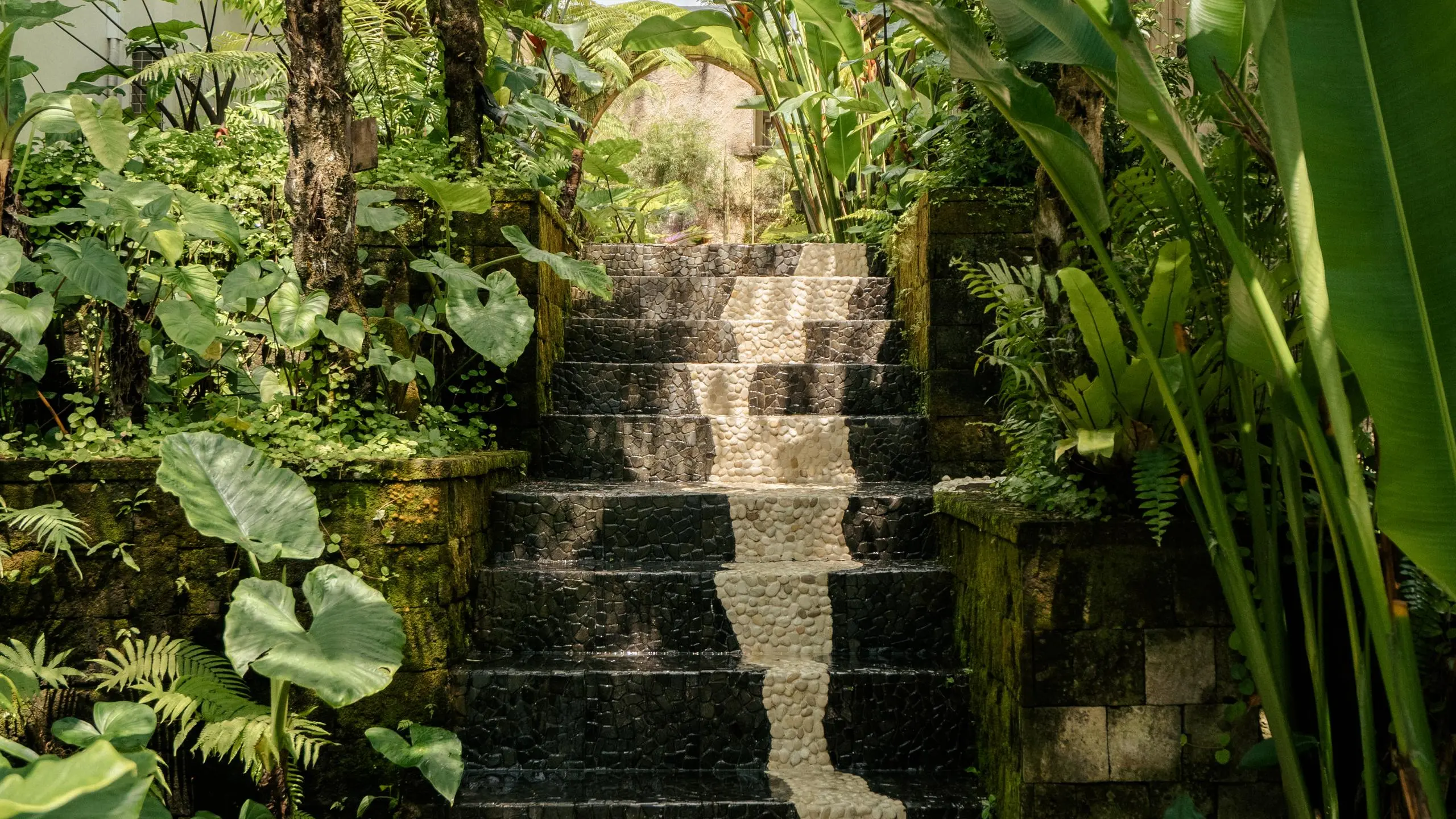 Group walking up stone stairs in Bali, representing Bali group travel coordination