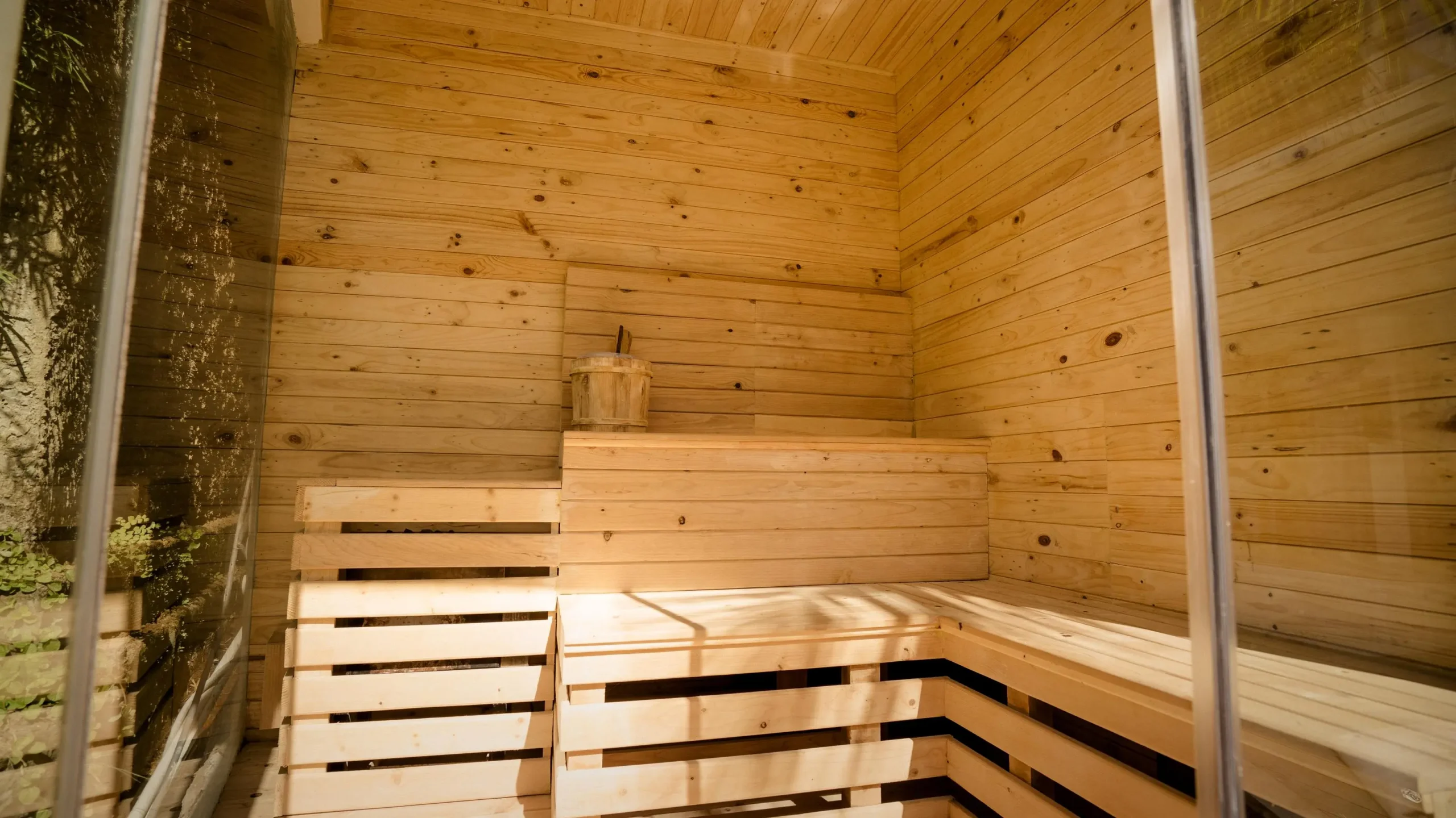 Finnish sauna with wooden walls and bench at a Bali retreat