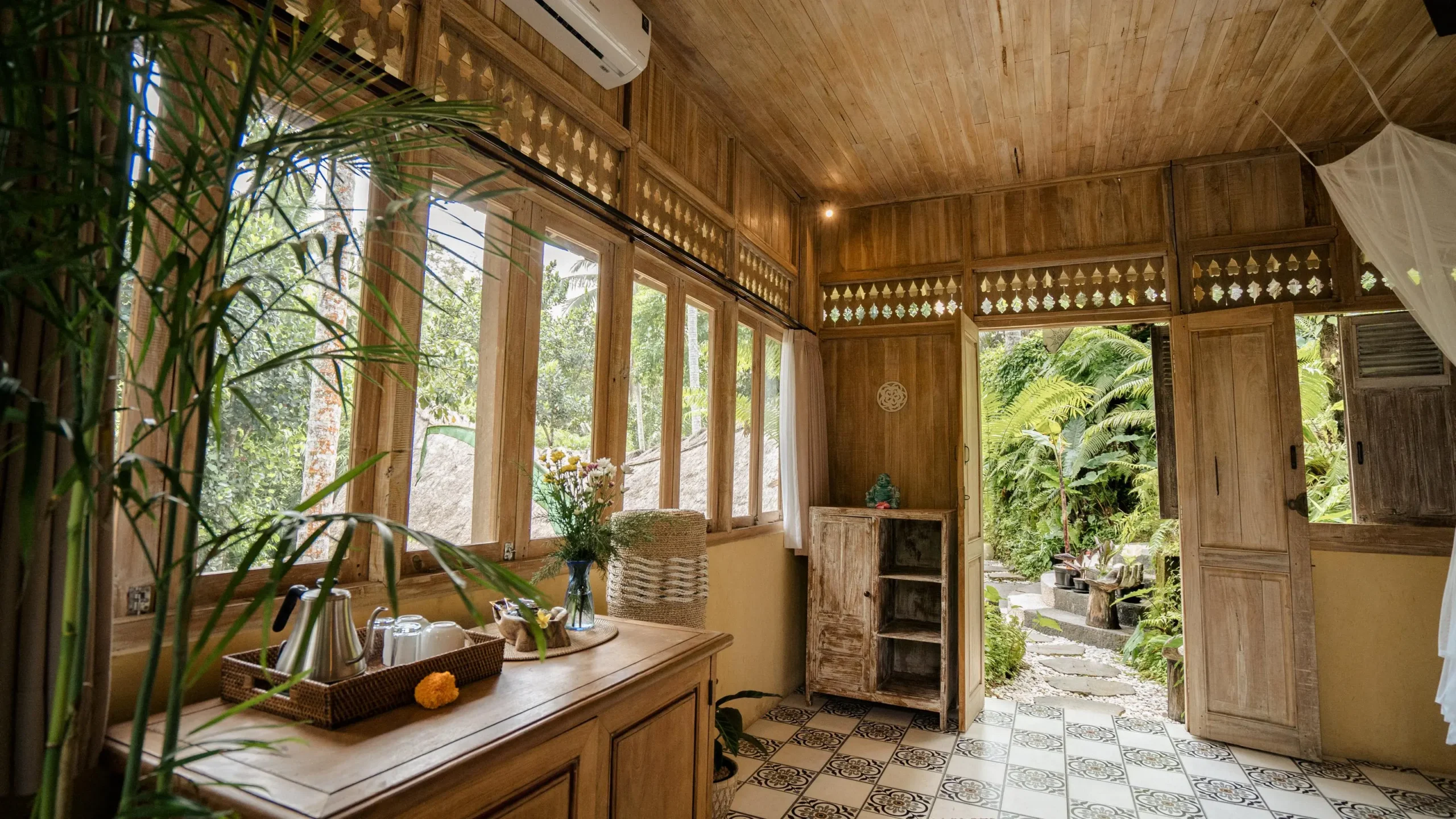 Luxury villa room setup for group bookings Bali retreat with bed, table, and scenic window view